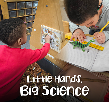 Little Hands. Big Science. Two young students working with ruler and white board