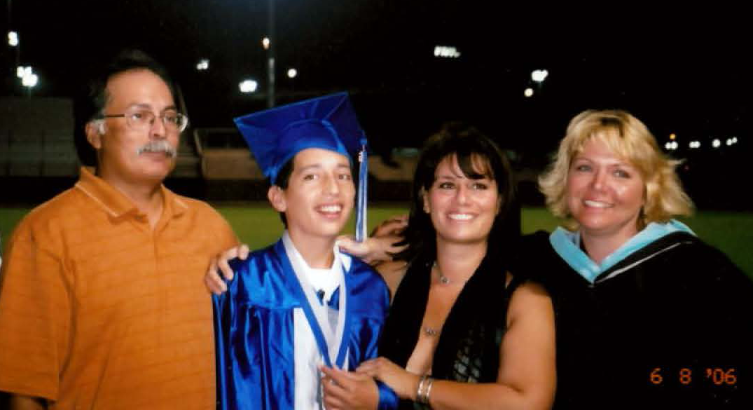 Denise Chappell with student and parents at graduation ceremony