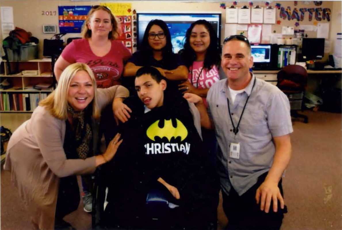 Denise Chappell and educator team pose with student in wheelchair